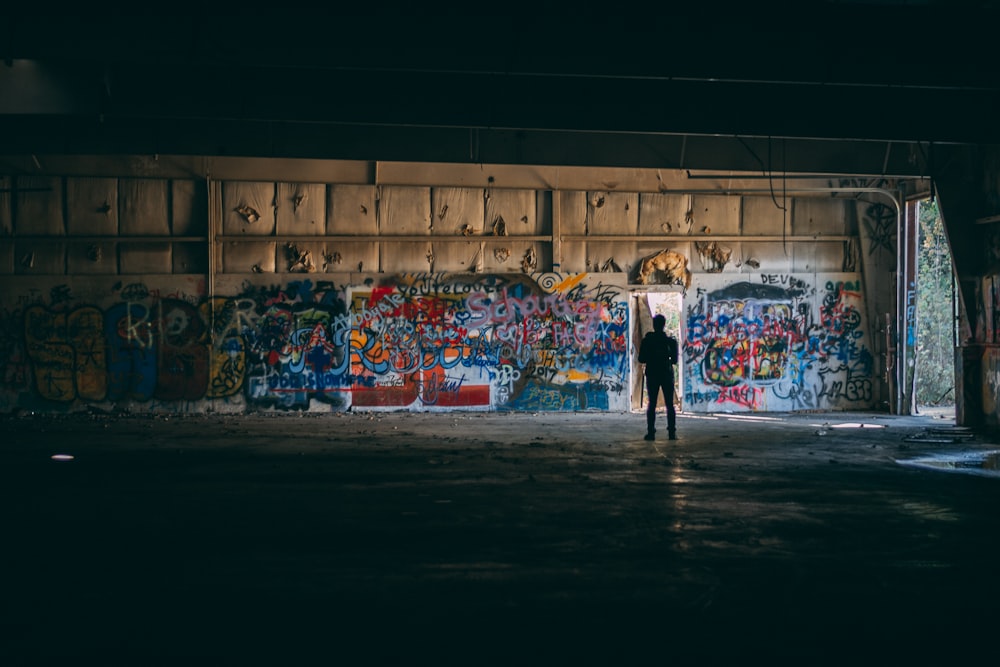 people walking on street with graffiti