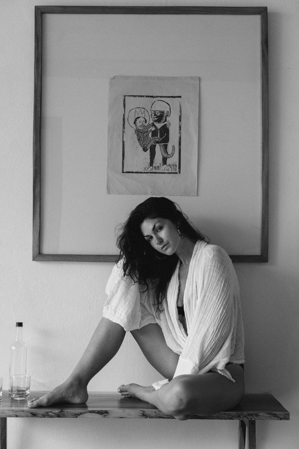 woman in white shirt sitting on sink