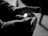 Close-up of a firefighter’s hands adjusting ignisguard gloves with flames softly glowing in the background.