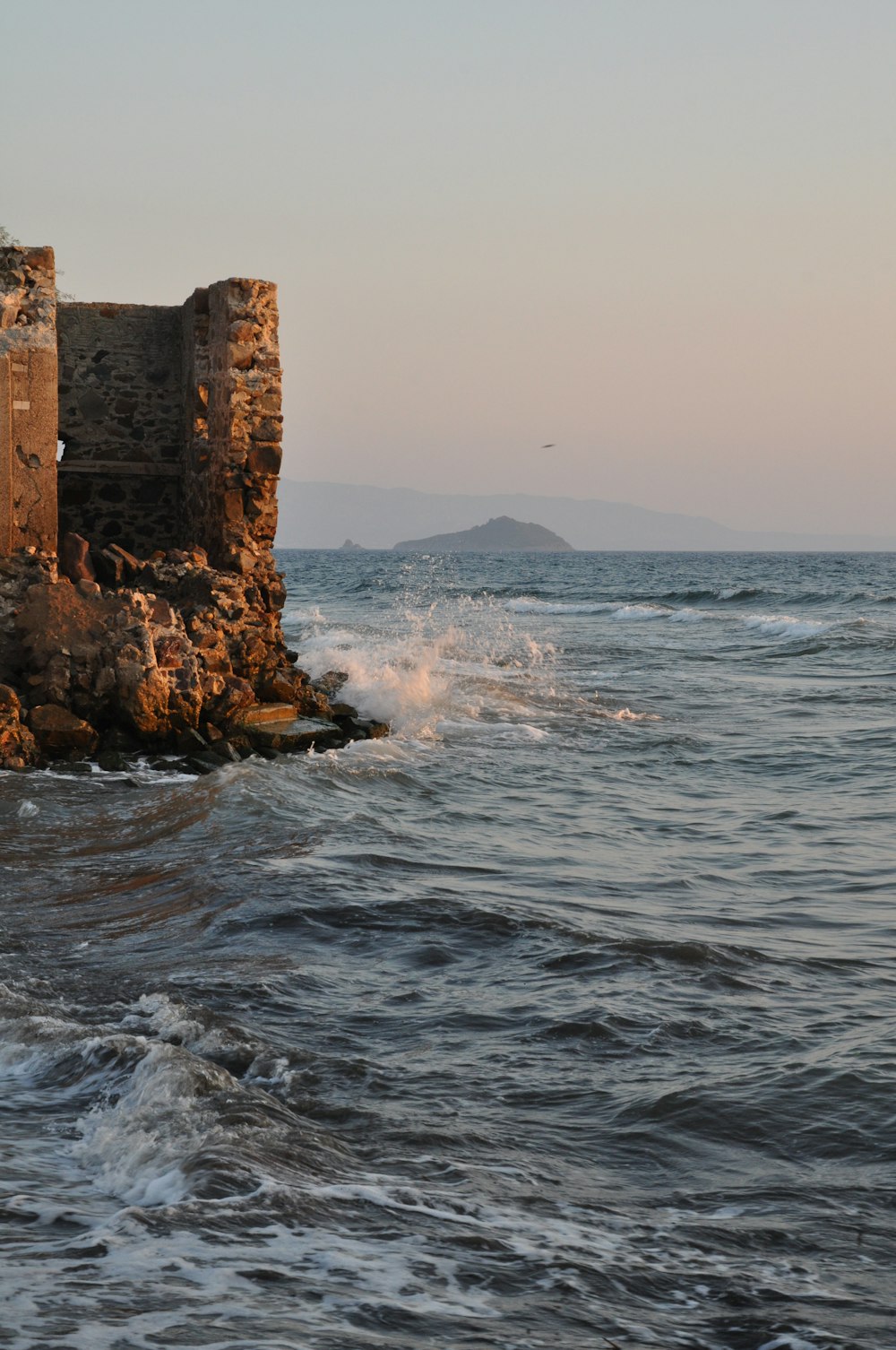 brown rock formation on sea during daytime