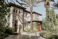 Charming Mediterranean-style estate surrounded by mature gardens in a quiet neighborhood.