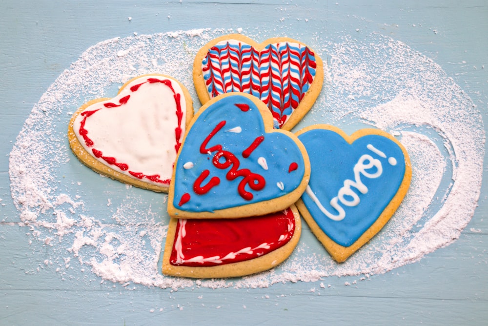 red and white heart shaped cake on white and blue floral textile