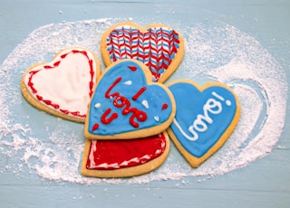 red and white heart shaped cake on white and blue floral textile
