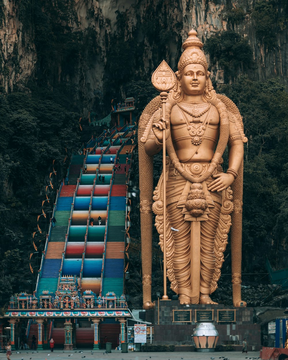 gold statue of man on top of building