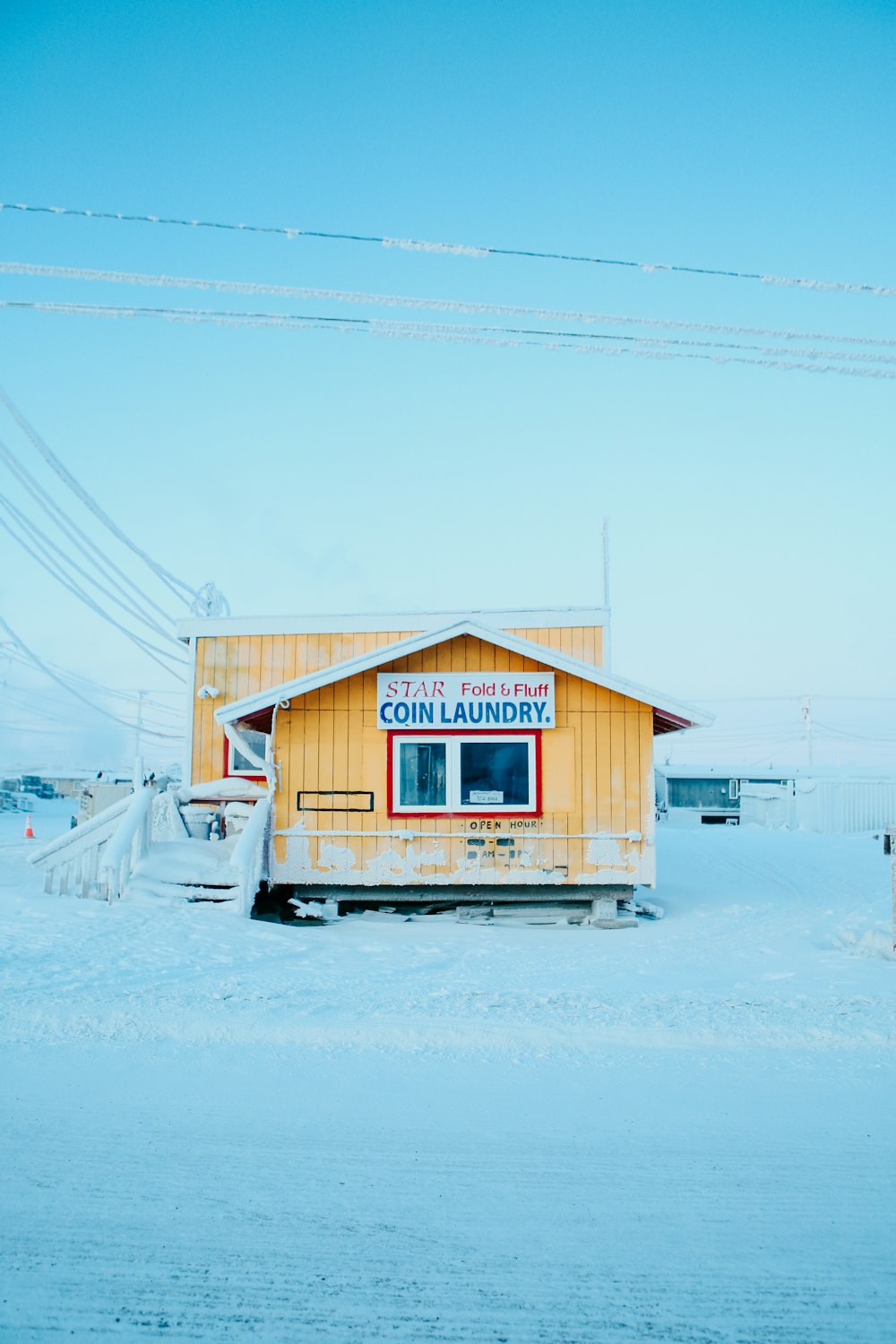 brown wooden house on snow covered ground during daytime