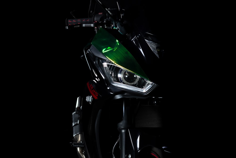 green and black motorcycle with black background
