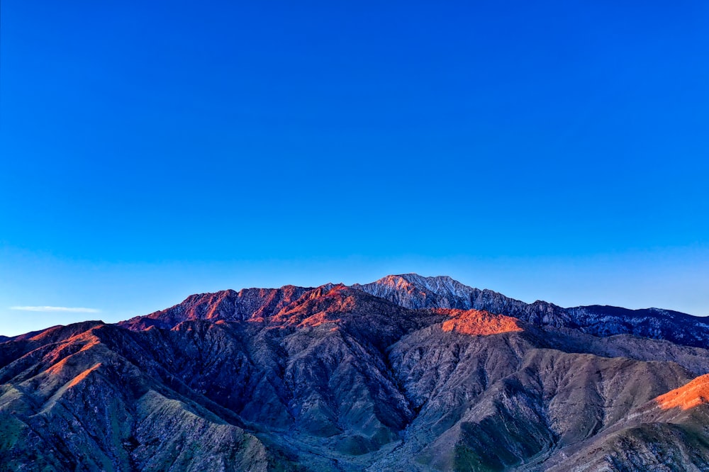 brown rocky mountain under blue sky during daytime