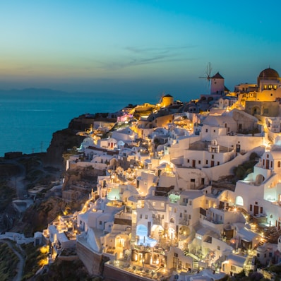 white and brown concrete houses on mountain near sea during daytime