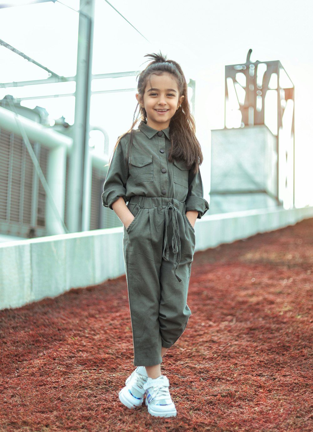 girl in gray coat standing on brown dried leaves during daytime