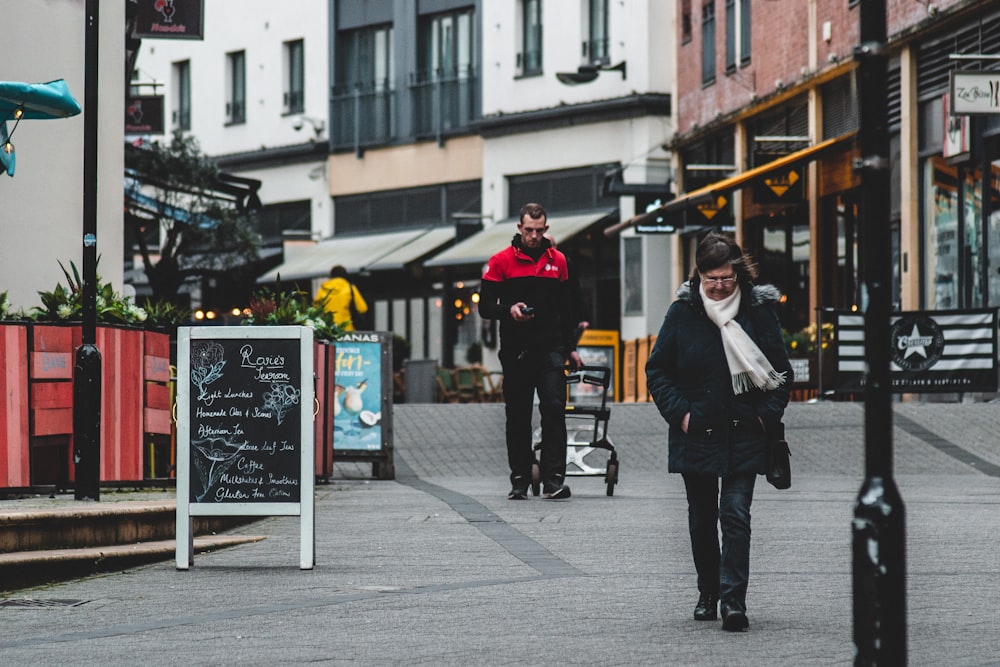 man in black coat standing beside man in black coat