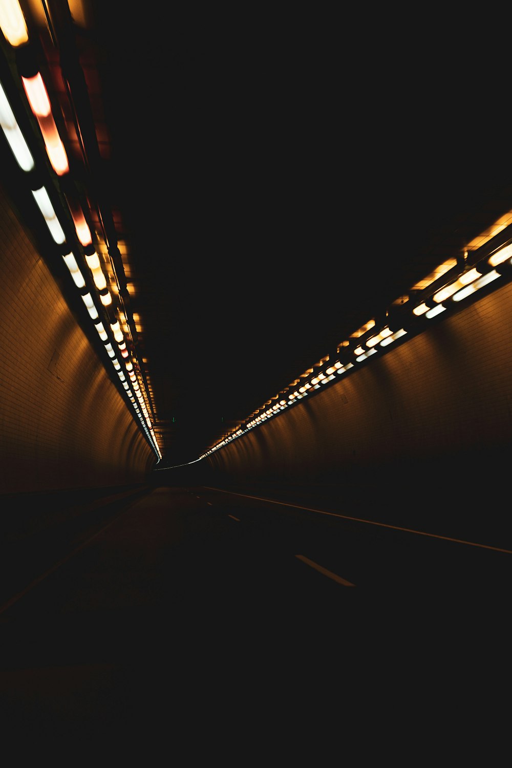 black and brown tunnel with lights