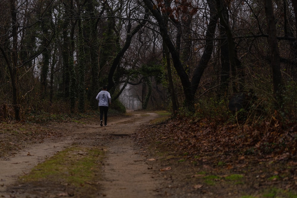 person in white jacket walking on pathway