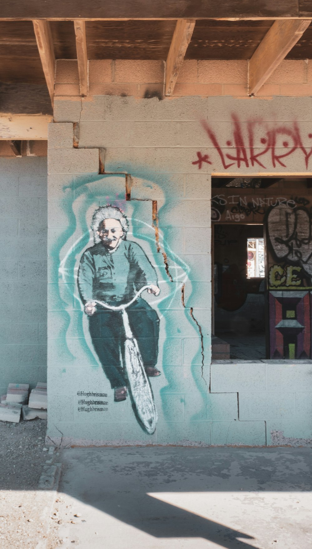 man in black jacket and black pants holding black and white electric guitar graffiti