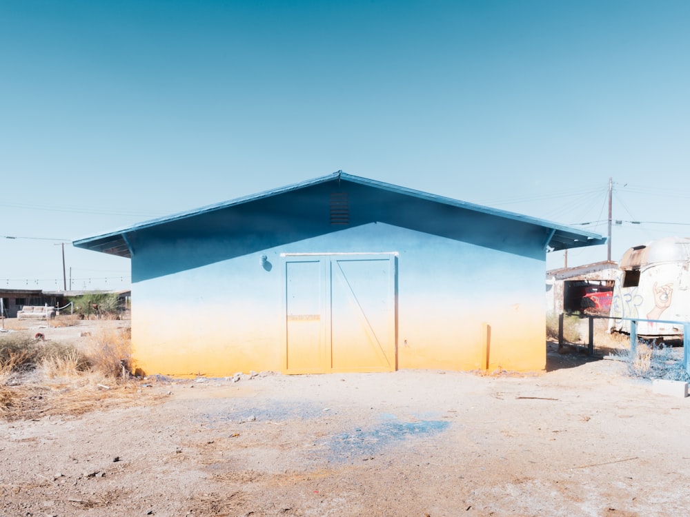 blue and yellow concrete building under blue sky during daytime