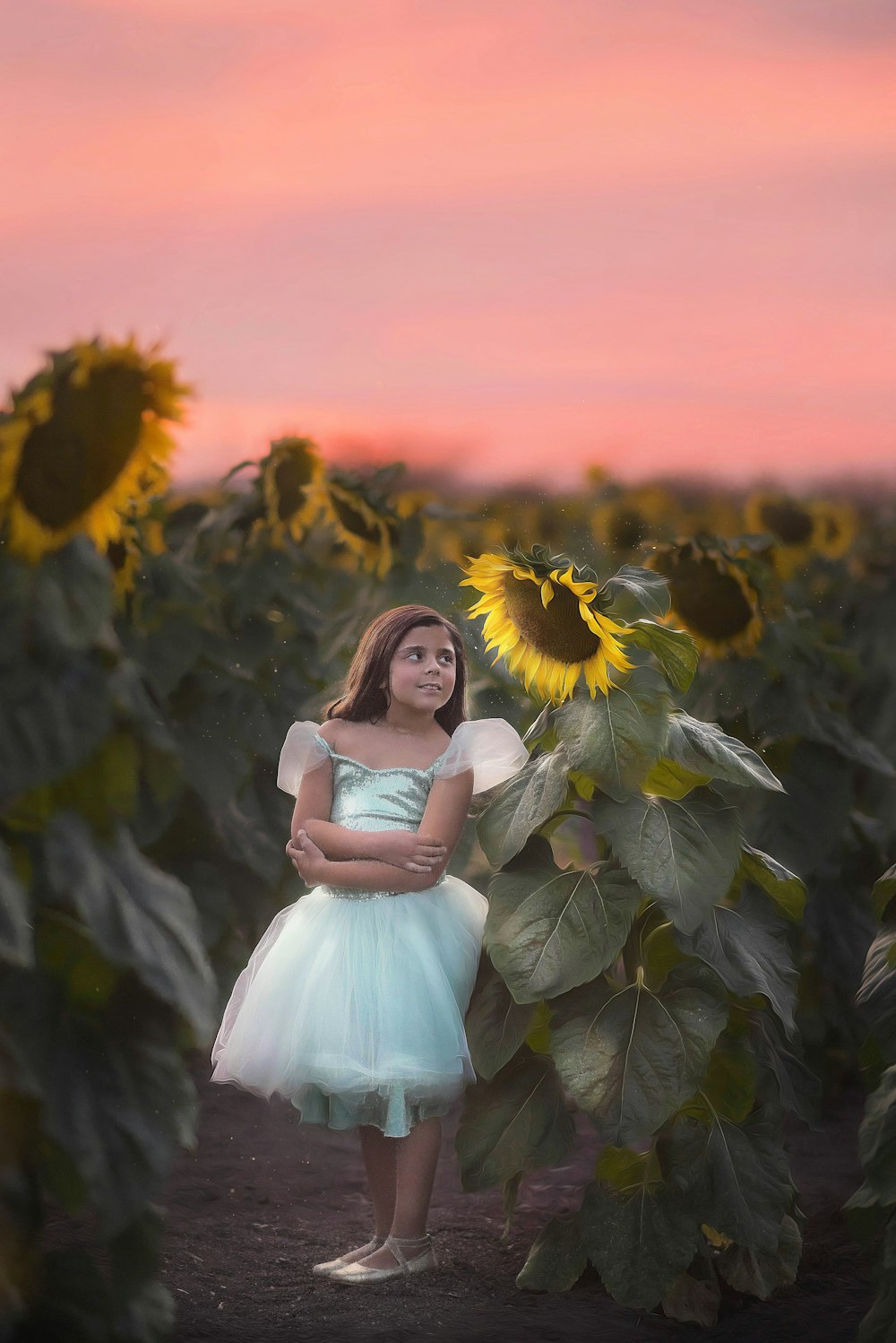 woman in white dress sitting on green plant