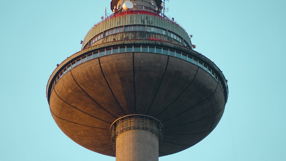 people on top of brown and gray tower