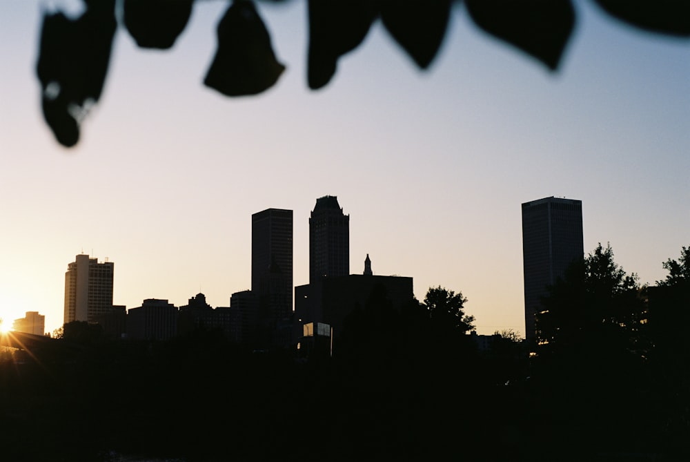 silhouette of city buildings during sunset