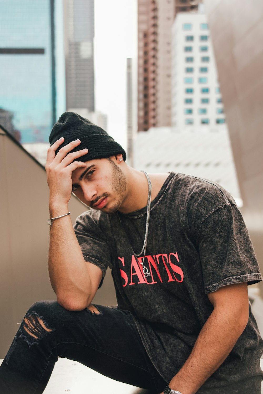 man in black and white crew neck t-shirt and black cap