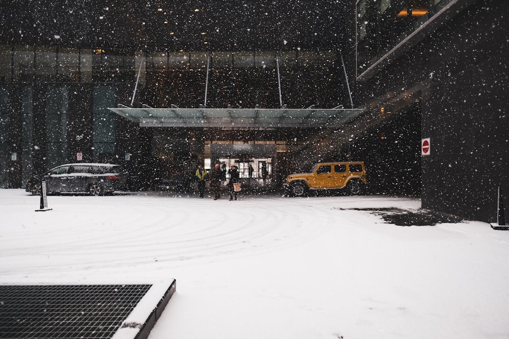 yellow taxi cab on snow covered field during daytime