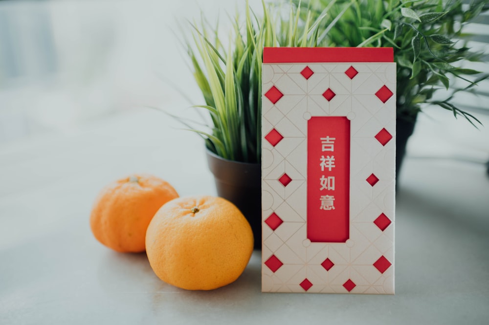 orange fruit on white and red checkered table