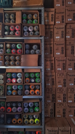 Shelves filled with various colorful paint cans in a construction materials store