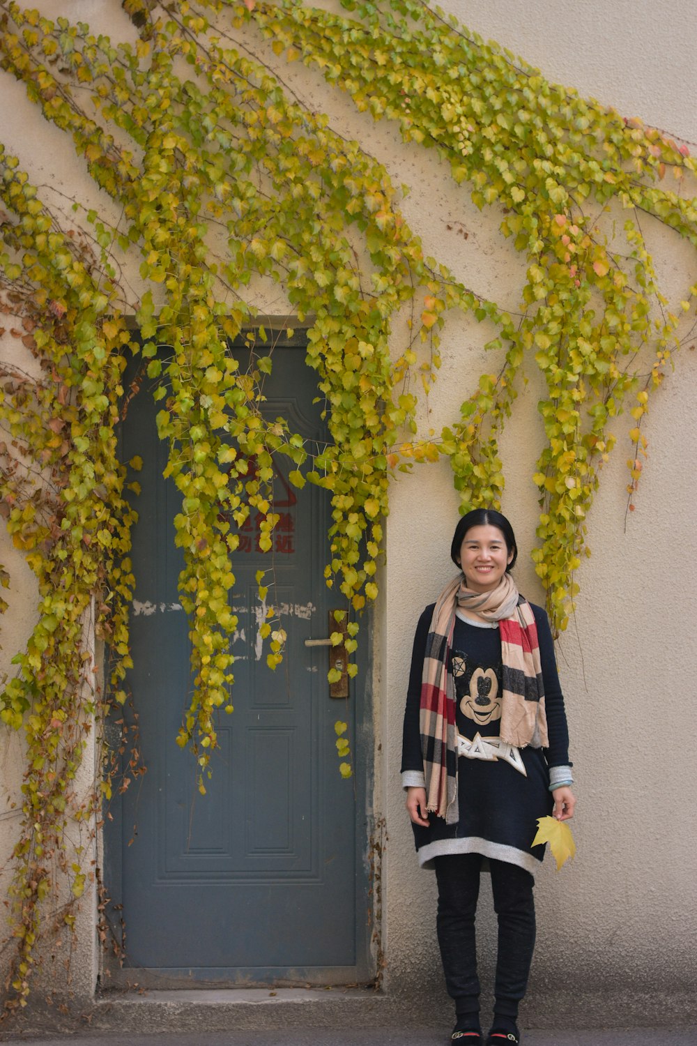 a woman is standing in front of a door