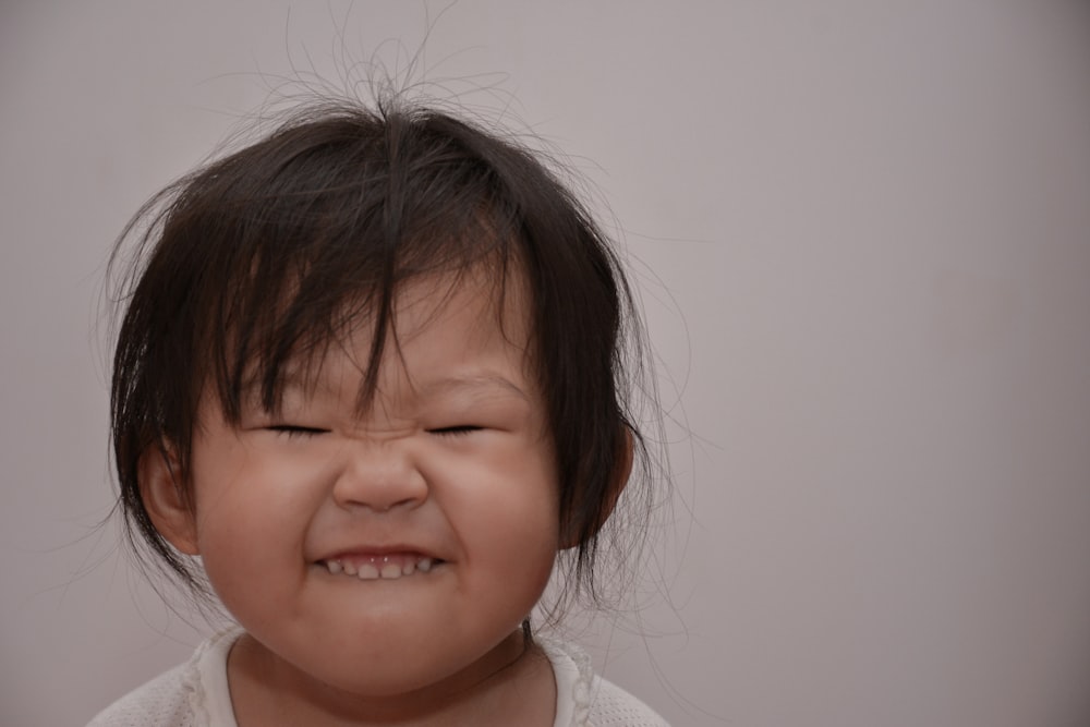 a little girl crying with her eyes closed