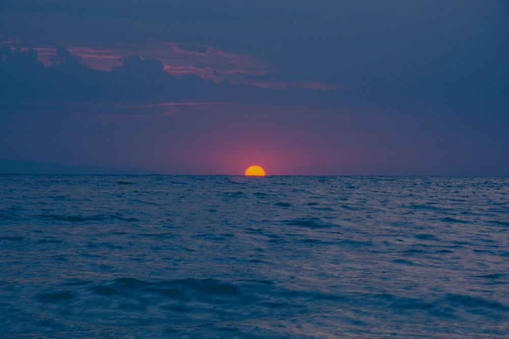 body of water during sunset