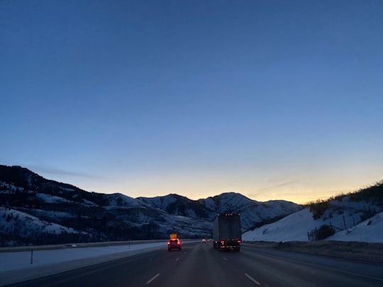 black car on road near snow covered mountain during daytime in Park City United States