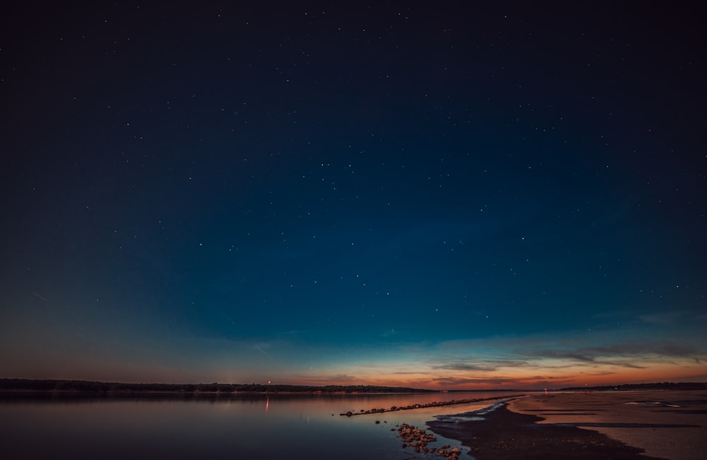 Gewässer unter blauem Himmel während der Nacht