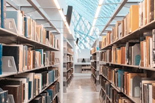 brown wooden book shelves in library