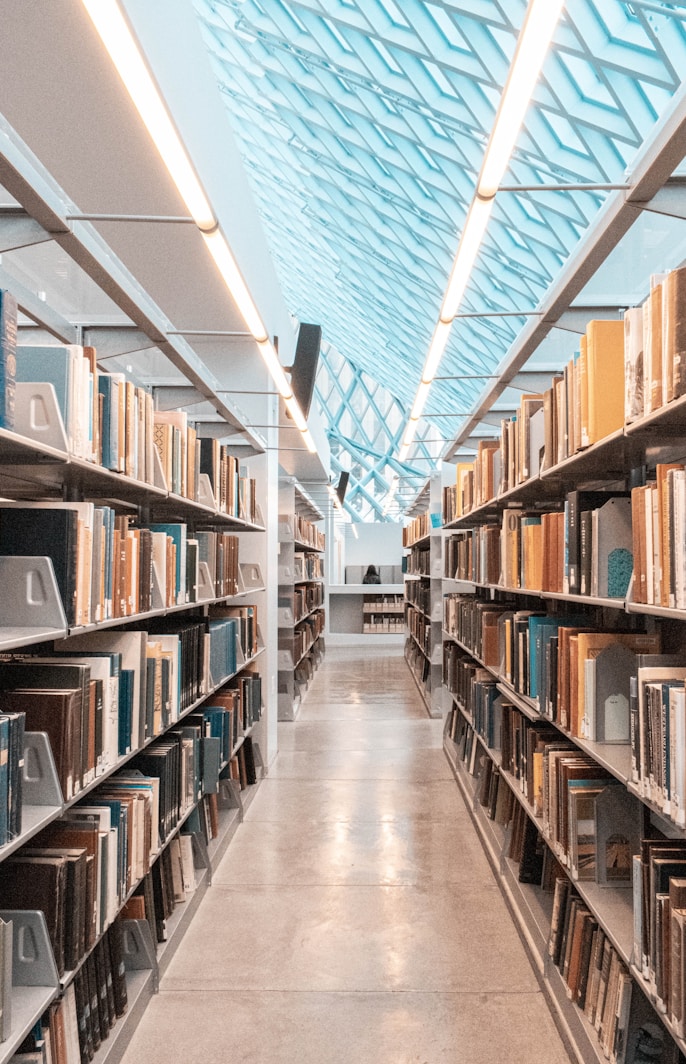 brown wooden book shelves in library