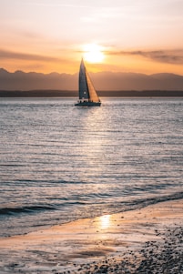 sailboat on sea during sunset