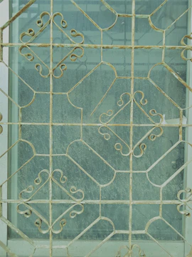 Detailed view of a sturdy metal protection grill on a window.