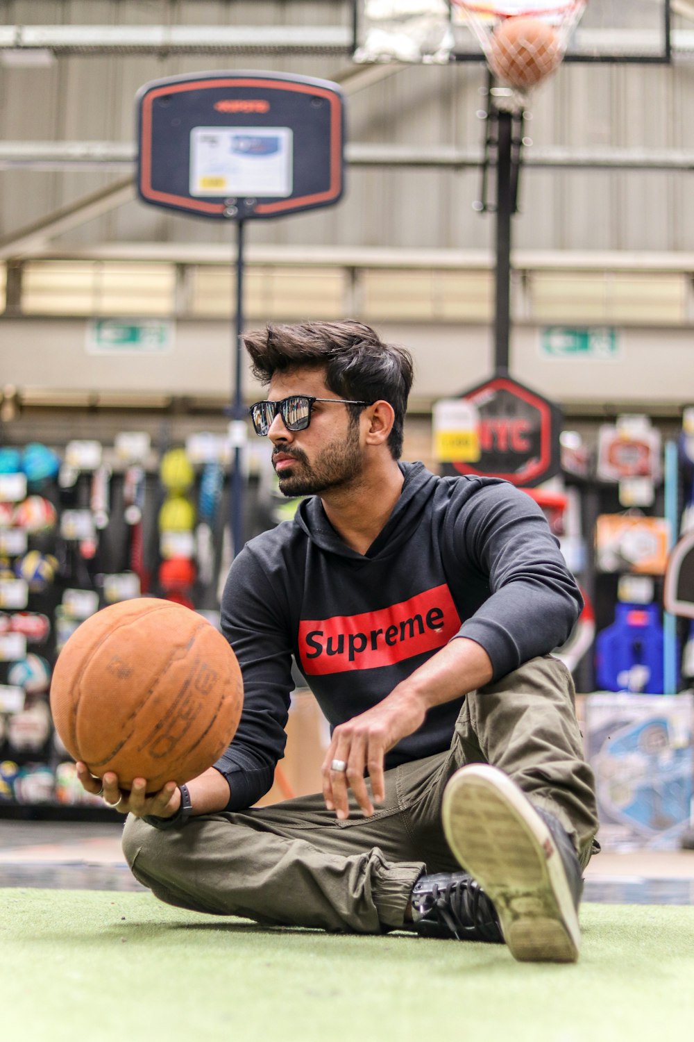 man in gray and red crew neck long sleeve shirt holding basketball