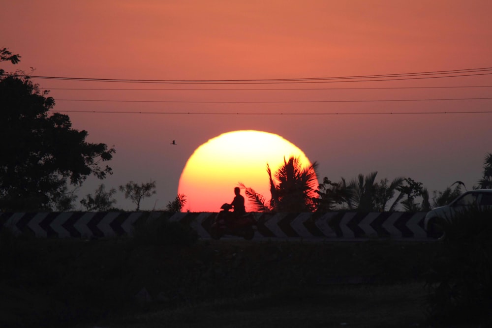 silhouette of man and woman kissing during night time