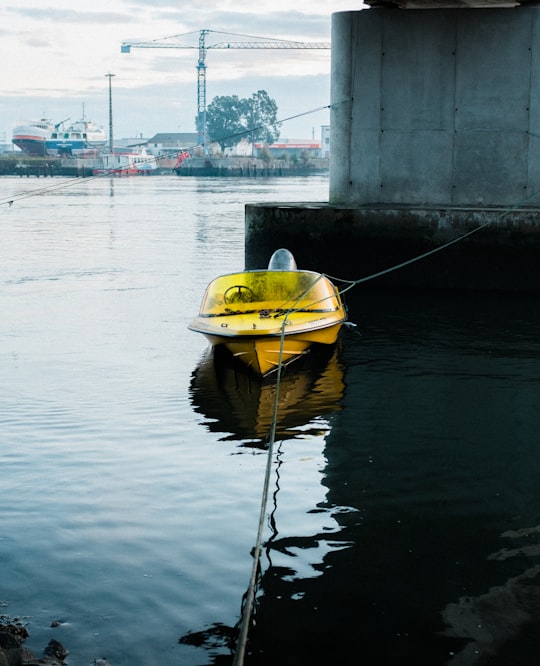 yellow kayak on body of water during daytime in Aveiro Portugal