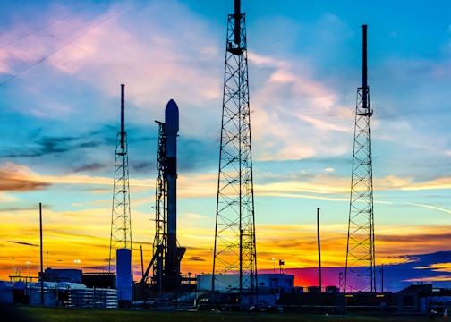 Close-up of researchers preparing scientific equipment for launch at sunrise.