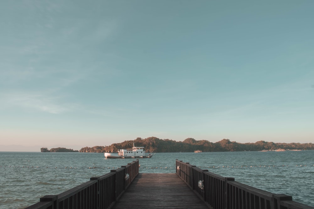 brown wooden dock on sea during daytime