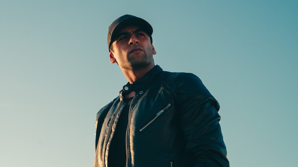 man in black leather jacket and black cap