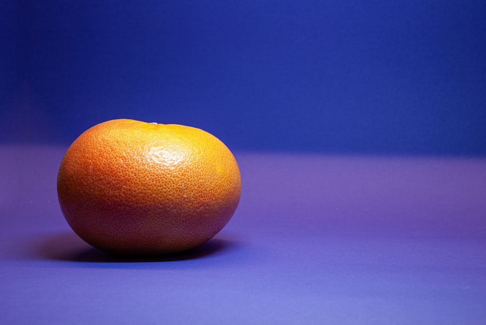orange fruit on purple textile