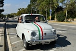 A classic vintage car shining under the Sicilian sun, ready for a wedding