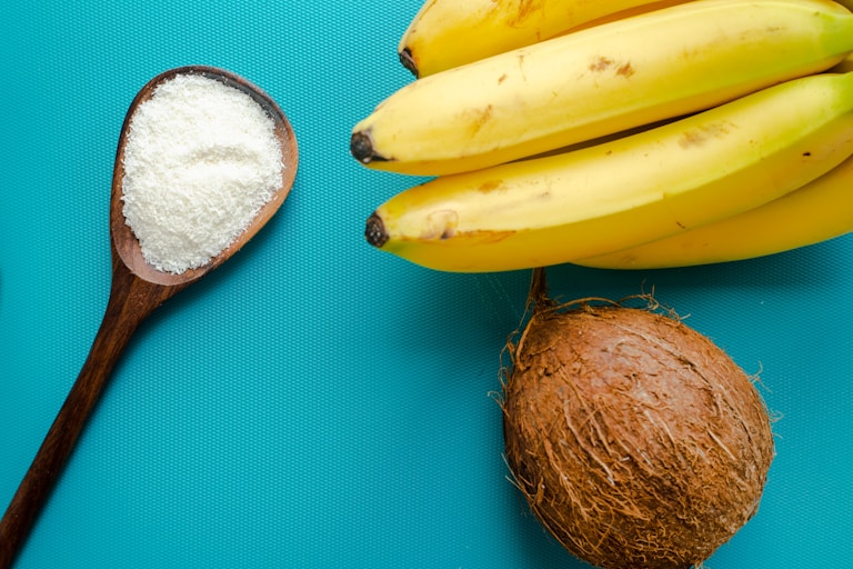 yellow banana fruit beside brown round fruit