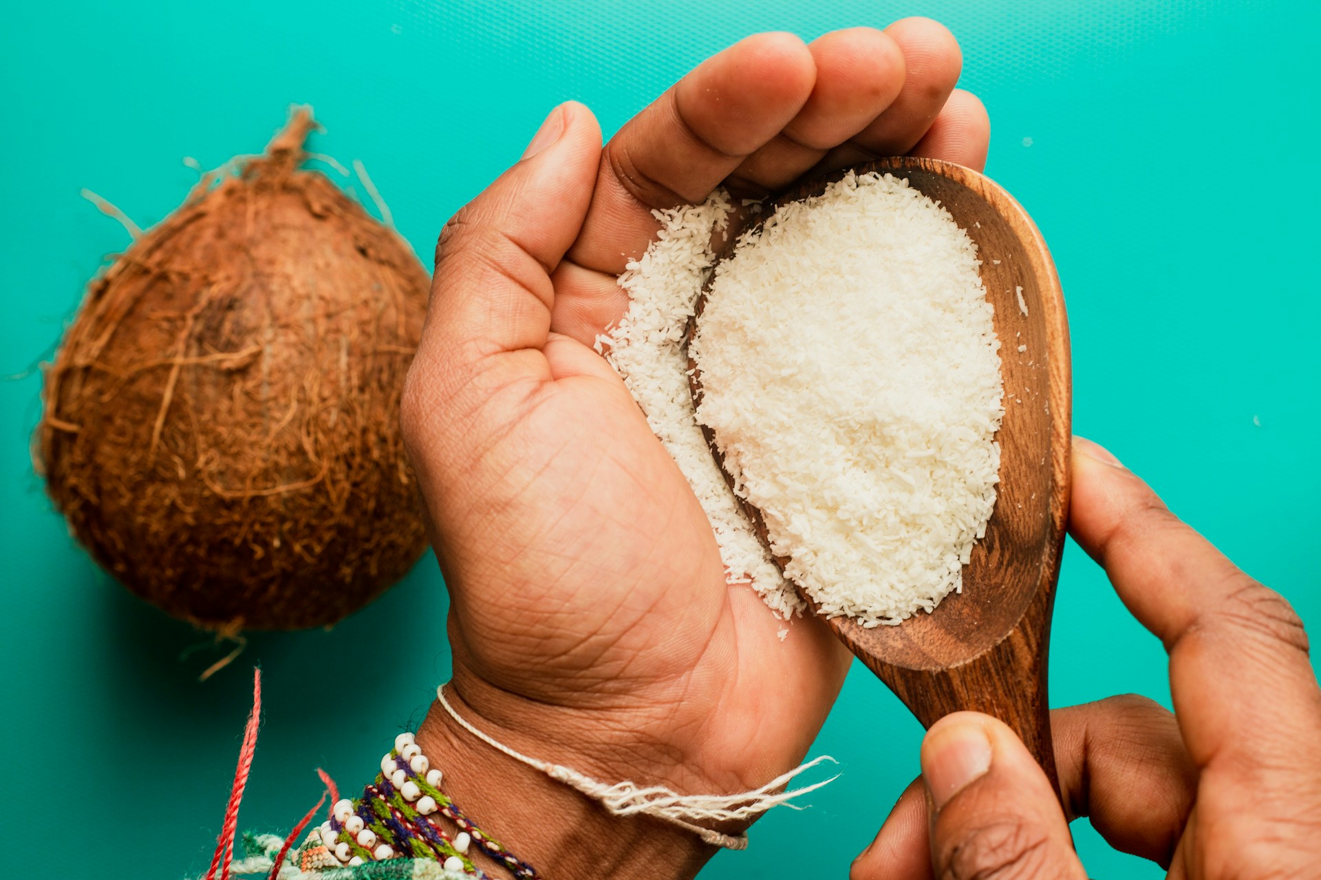 person holding coconut fruit with white powder