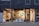A modern storefront with large glass windows featuring a display of various contemporary lamps and lighting fixtures. The interior is well-lit, showcasing a minimalist and stylish design, with a focus on modern lighting solutions. Visible elements include pendant lamps, floor lamps, and decorative objects arranged neatly. The exterior of the building has a dark-colored facade with vertical paneling.