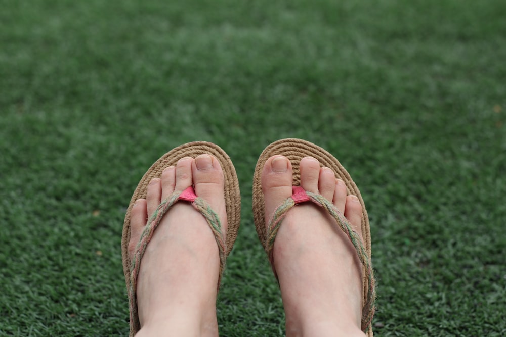 person wearing brown leather sandals