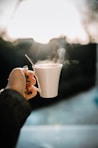 person holding white ceramic mug