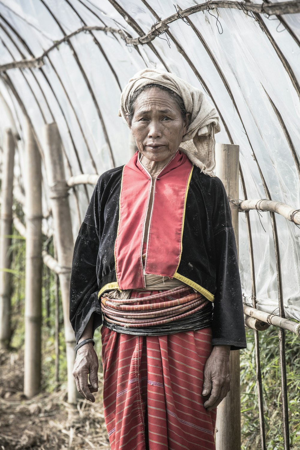 woman in red and black dress wearing black and red scarf