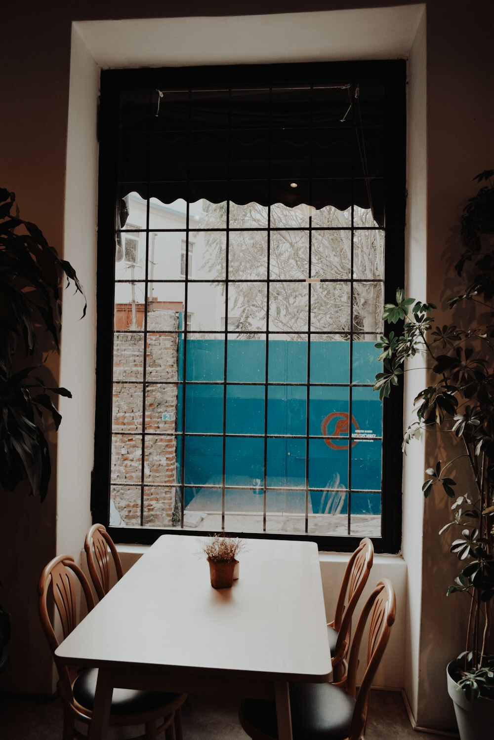 white wooden table near window