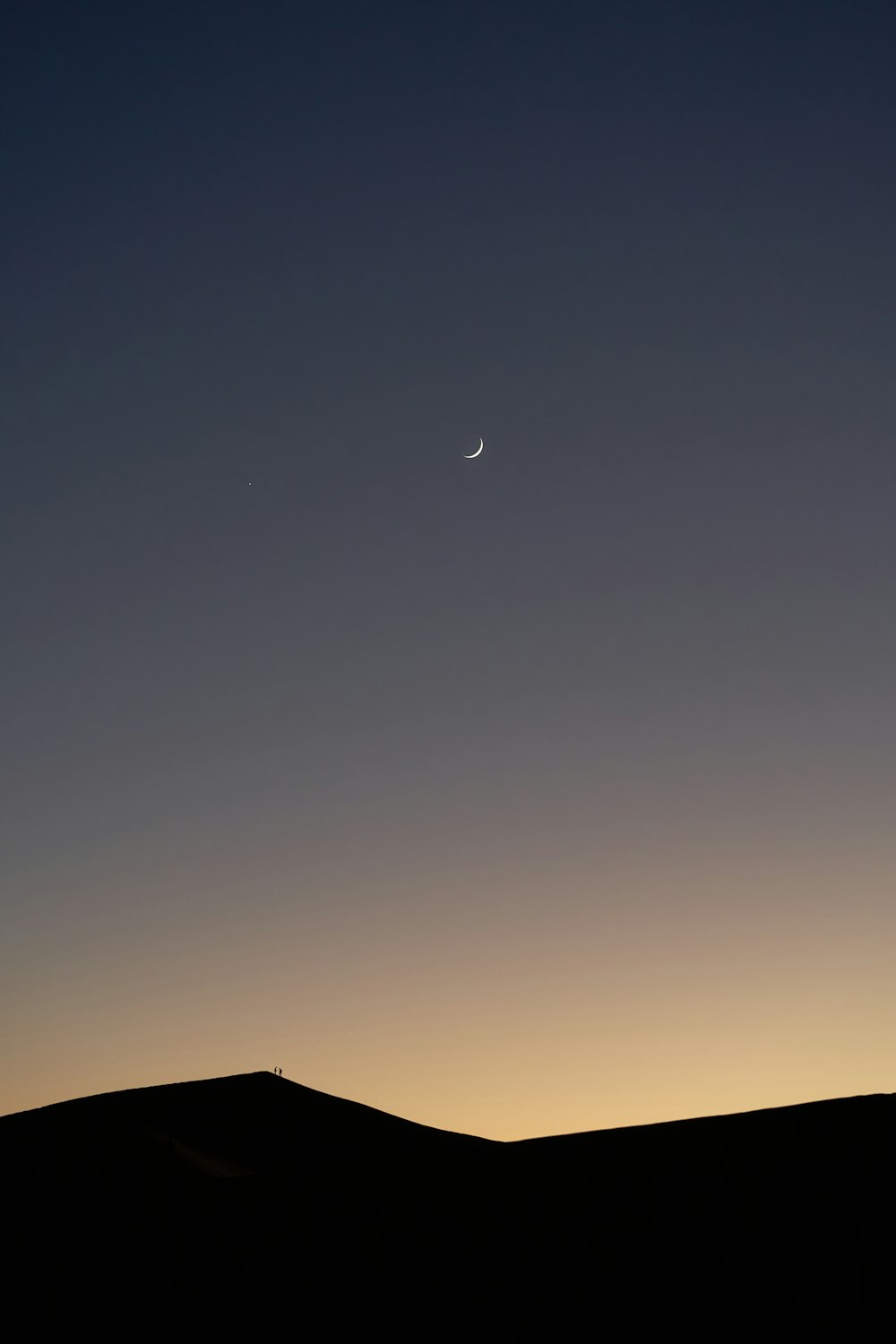 silhouette of house under blue sky during night time